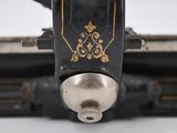 close up of a sewing machine with a needle on the side of it