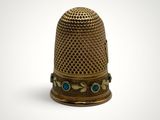 a close up of a thimble on a white background