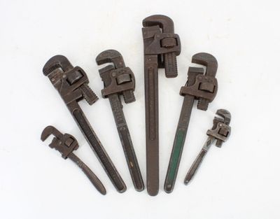 six old pipe wrens are lined up on a white surface