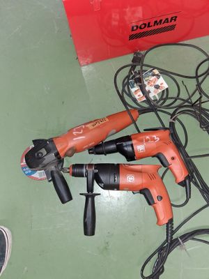 two electric tools on the floor next to a red box