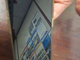 a person holding a mirror with a picture of a building in it