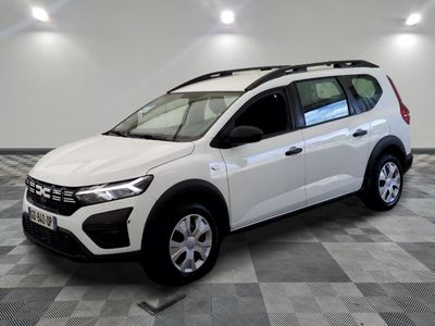the white car is parked on a checkered floor in a room