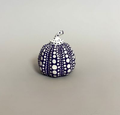 a close up of a small blue and white object on a table