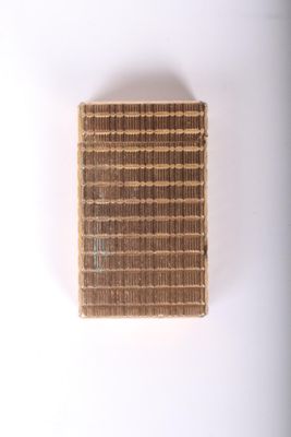 un gros plan sur un petit morceau de carton carré posé sur une surface blanche