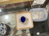 a ring with a blue stone on it in a display case