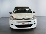 a white car that is parked in a room