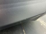 a close up of a car ' s bumper with a small hole in it