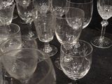 many empty wine glasses sitting on a black table