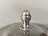 a close up of a silver lid on a silver pot