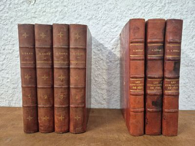 two books sitting on top of a wooden table next to each other