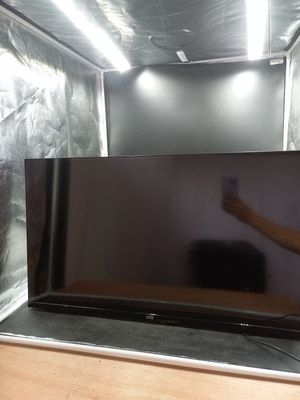 un homme debout devant un téléviseur à écran plat