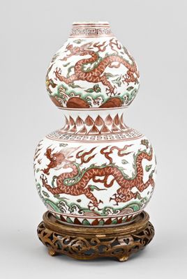 an image of a vase with a dragon on it on a stand