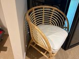 a wicker chair in the corner of a room
