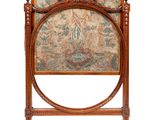 a chair that has a tapestry on the back of it