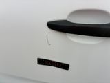 a sticker on the door handle of a white car
