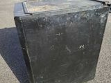 a black box sitting in the middle of a parking lot
