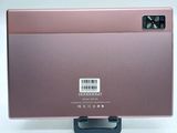the back of a pink laptop with a barcode on it