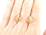 someone is holding a pair of gold rings in their hand