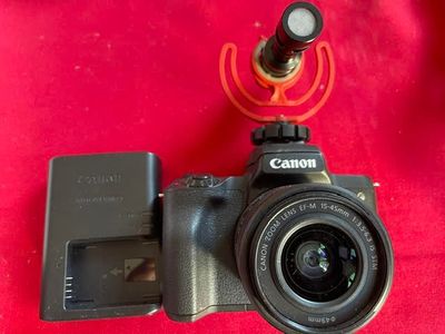 a canon camera with a battery attached to it