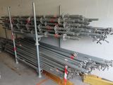 a lot of metal pipes that are stacked on a rack