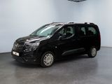 the black van is parked in a large room with white walls