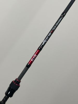 a close up of a fishing rod with a red handle