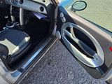 a small car with its door open on the side of the road