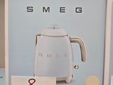 a box with a picture of a white coffee maker on it