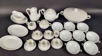 many white dishes and cups and saucers on the table