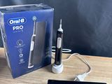 a box of toothbrushes sitting on a table next to a charger