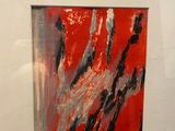 a picture of a red and black painting in a white frame