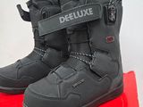 pair of black snow boots sitting on top of a red box
