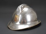 a silver helmet that is sitting on a table