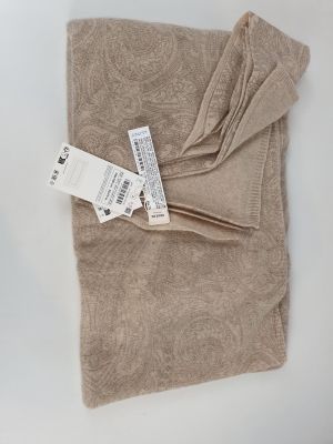 the blanket has a tag on it on a white surface