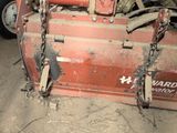 a tractor with chains attached to the front of it