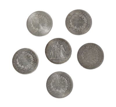 six silver coins are arranged in a circle on a white surface