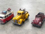 three toy cars that are sitting next to each other