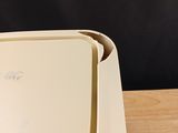 a white box sitting on top of a wooden table