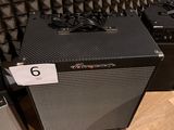 two amps sitting on the floor in front of a wall