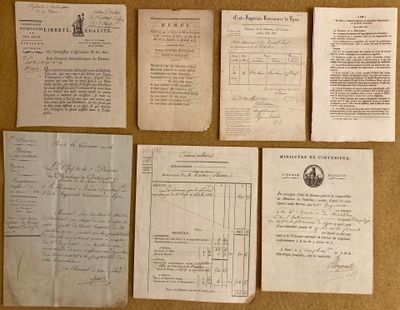 several old papers are on a table with a pen and ink