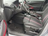 the interior of a car with red trims and black seats