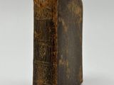 an old book sitting on top of a table next to a white background