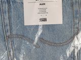 the back pocket of a pair of jeans with a tag on it
