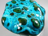 blue and green agate with black spots on a clear base