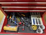 a red tool box with tools in it on the floor