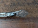a wrenet on a wooden table with a metal handle