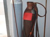 a gas bottle and a hose next to a fire extinguisher