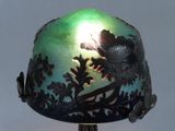 an image of a green and black vase with a bird on it