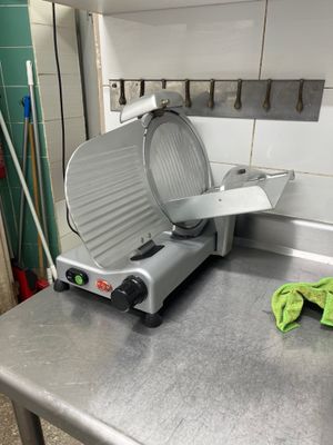 a large metal cutting machine on a counter in a kitchen