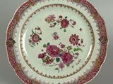 an image of a plate with flowers on it on a stand